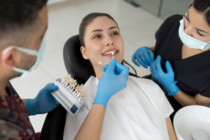 Dentist matching porcelain veneers to a patient’s teeth in Martinsburg, WV