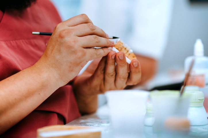 Dentist examining a dental model of teeth